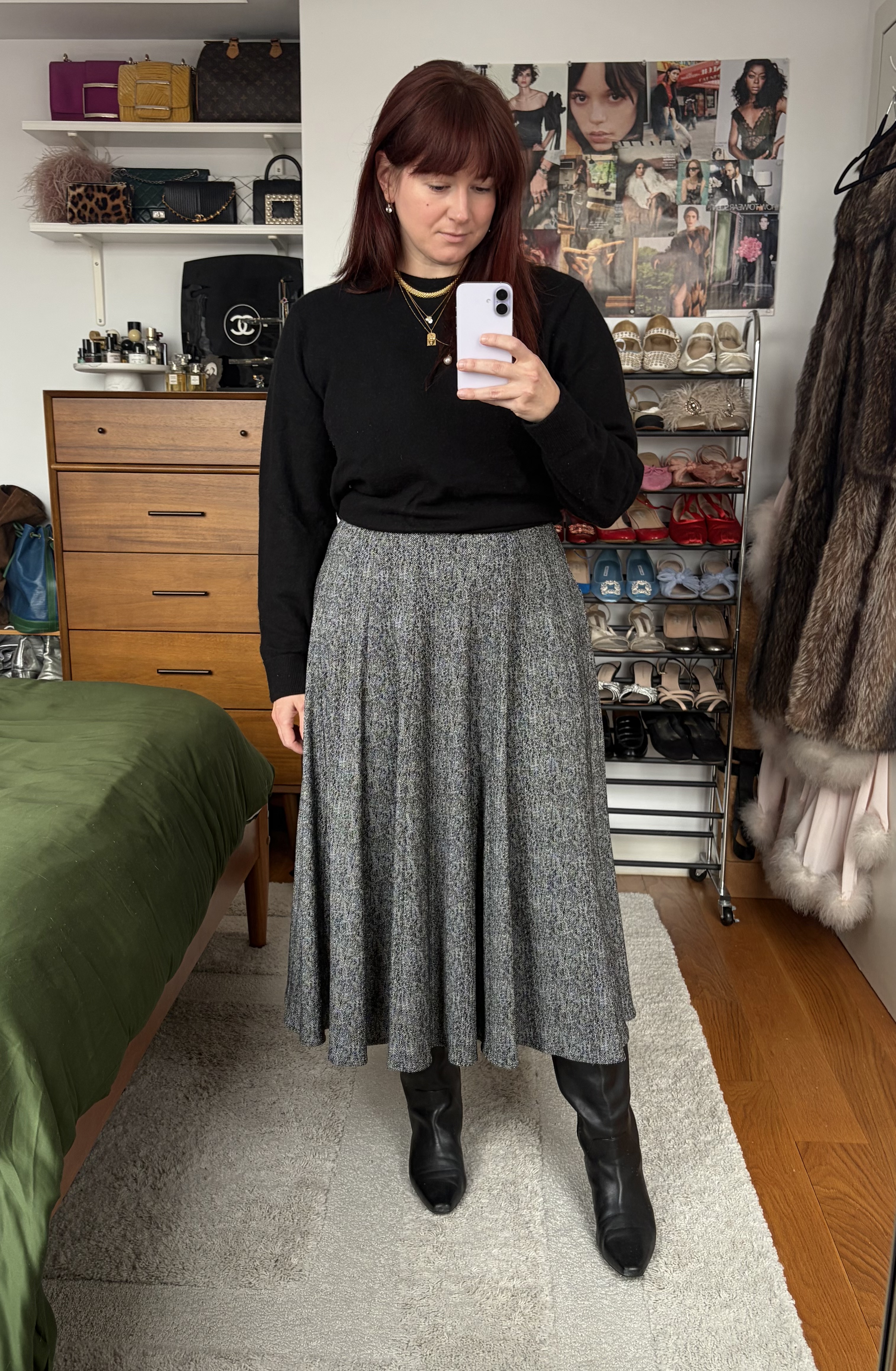 Tyler McCall wearing J.Crew's black mens cashmere sweater, black and white skirt, and black leather boots