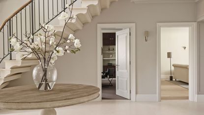 Hallway, grand entrance, round table, vase of flowers, tiled floor