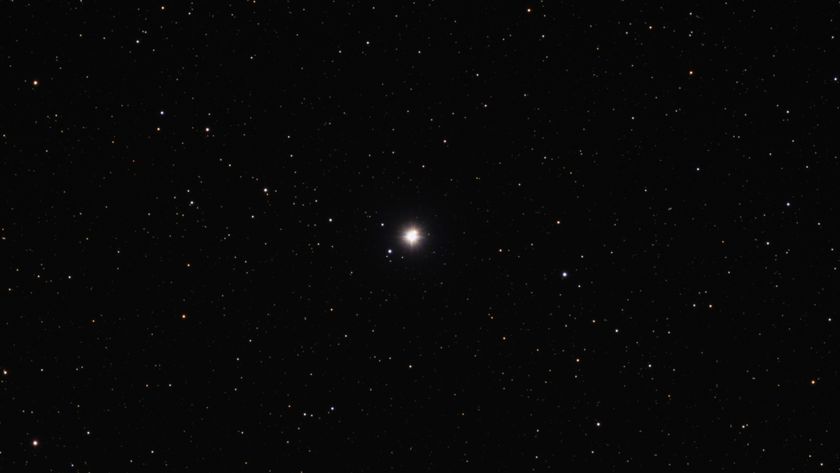 A bright dot of a star in the darkness of space with stars all around.