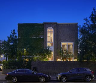 Emmanuel House by Dominic McKenzie Architects nighttime exterior lit from within