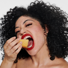 woman wearing lipstick and eating cake