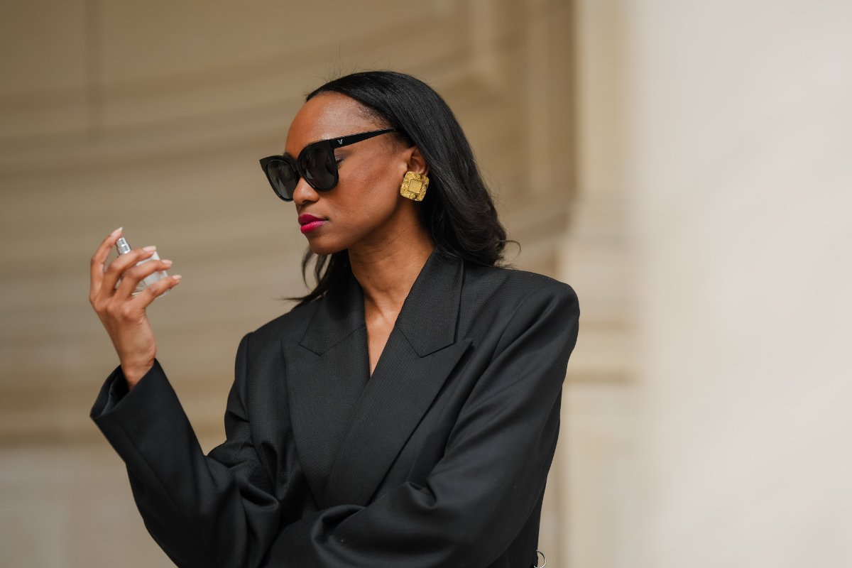 How to tell if perfume has expired Emilie Joseph wears sunglasses, golden earrings, red lipstick, a black oversize blazer jacket, uses a bottle of perfume during a street style fashion photo session, on May 12, 2024 in Paris, France