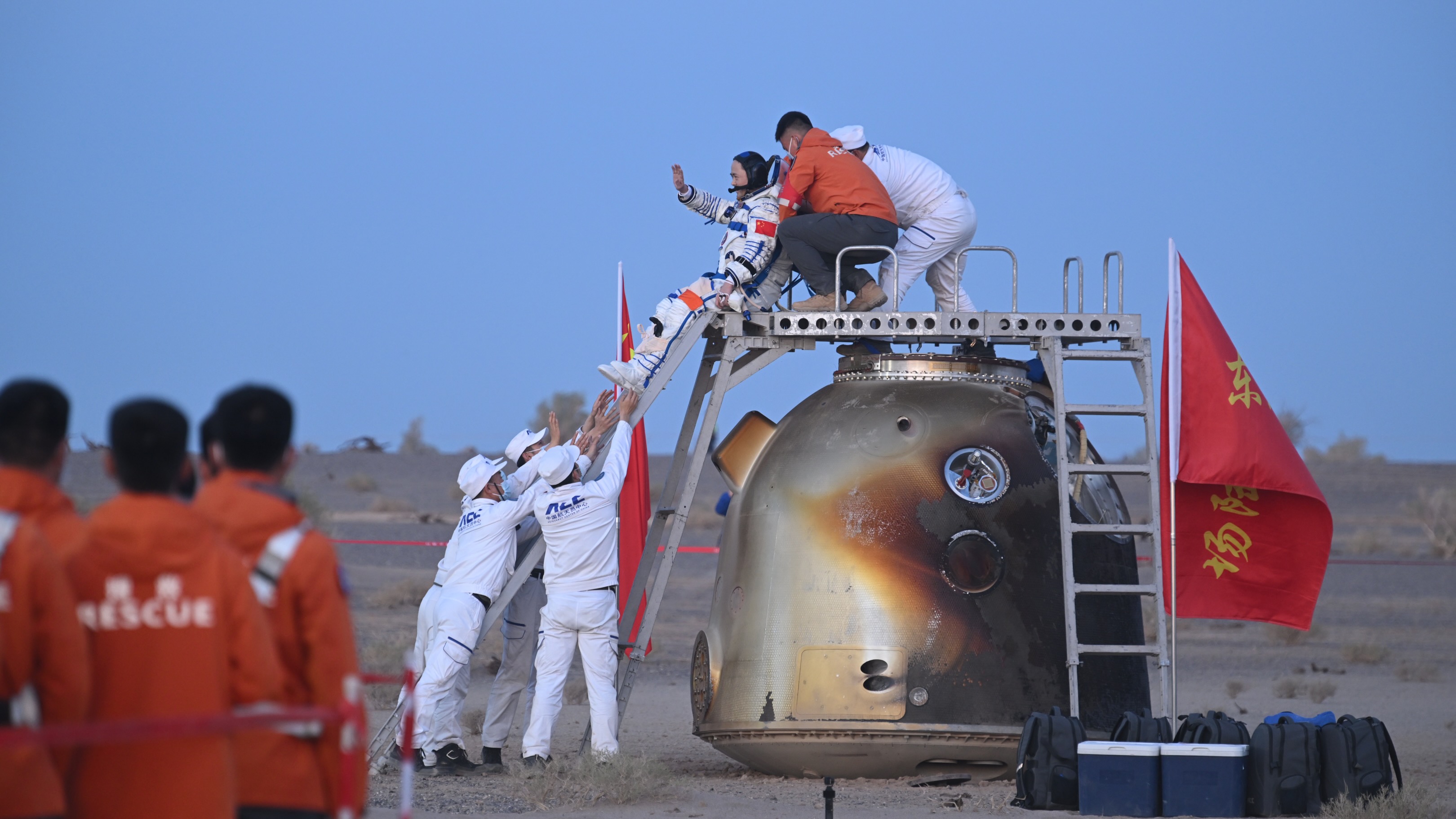 Recovery crews help astronaut Zhang Lu of the Shenzhou 21 mission out of his spacecraft shortly after it touched down safely at the Dongfeng Landing Site on May 29, 2026 in Inner Mongolia. 