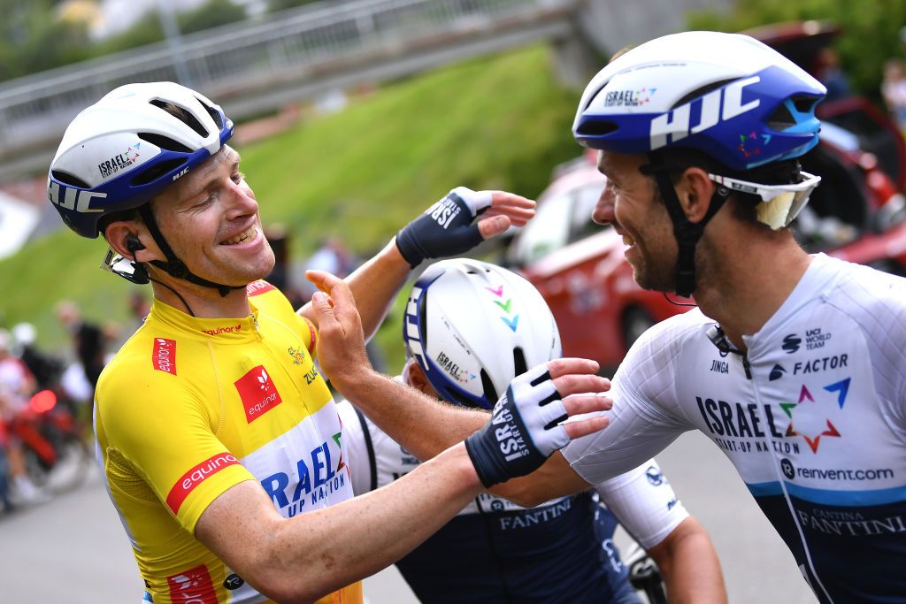 HARSTAD NORWAY AUGUST 08 Ben Hermans of Belgium and Team Israel StartUp Nation Yellow Leader Jersey celebrates at finish line with Teammates as race winner during the 8th Arctic Race Of Norway 2021 Stage 4 a 1635km stage from Gratangen to Harstad 54m ArcticRace on August 08 2021 in Harstad Norway Photo by Stuart FranklinGetty Images