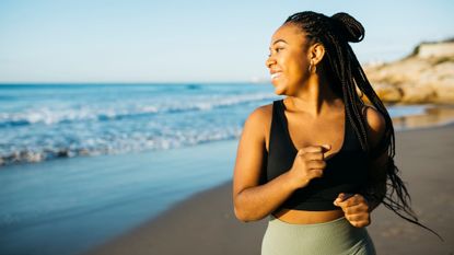 Blue zone living: A woman running on the beach near the ocean