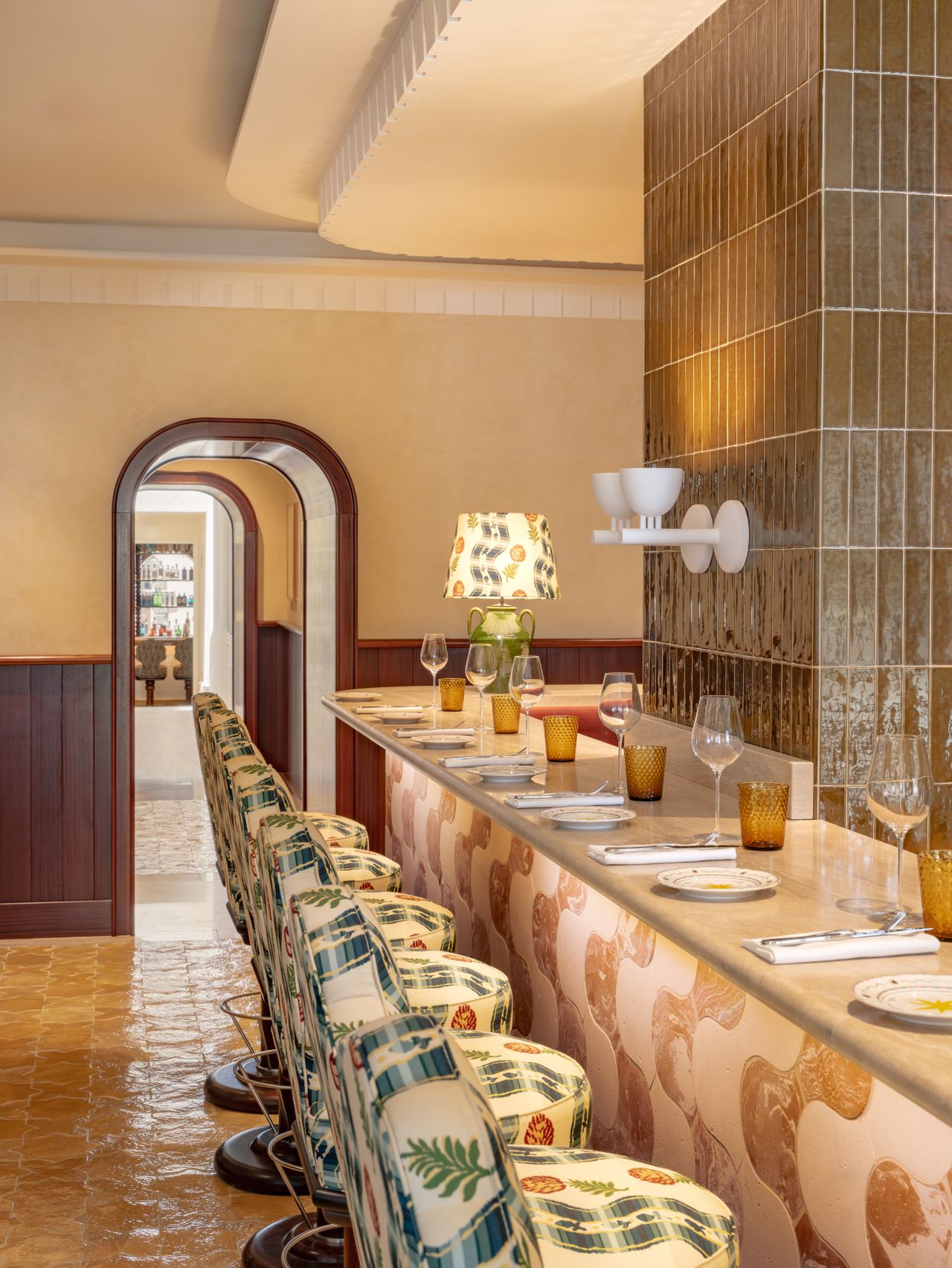 A maximalist hotel features contrasting textures, textiles, and shapes for a striking and retro-fueled effect.