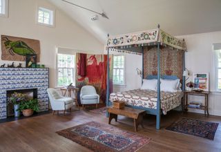 Four poster bed with embroidered topping, tiled fireplace