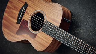 Taylor GS Mini beginner acoustic guitar on a dark background