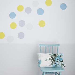confetti wall with blue chair and cushion