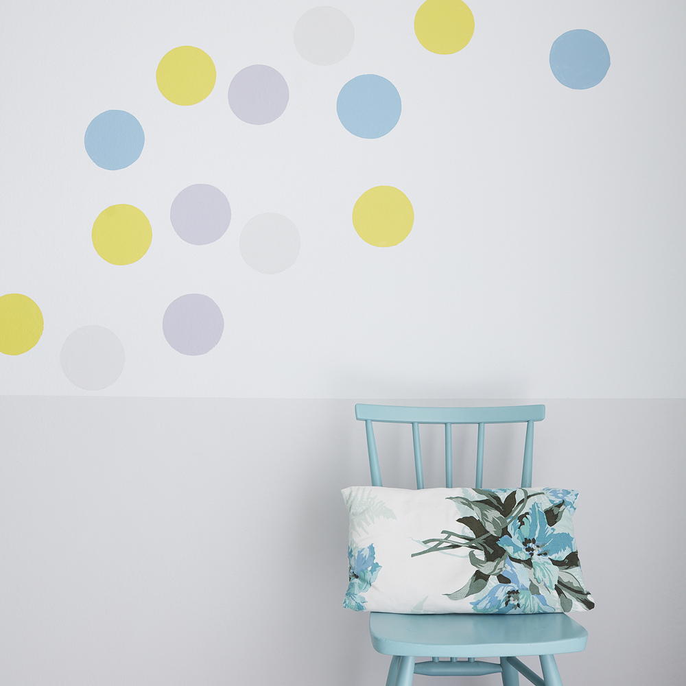confetti wall with blue chair and cushion