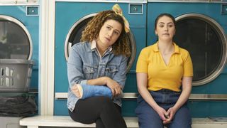 Rose Matafeo sits in a launderette in Starstruck