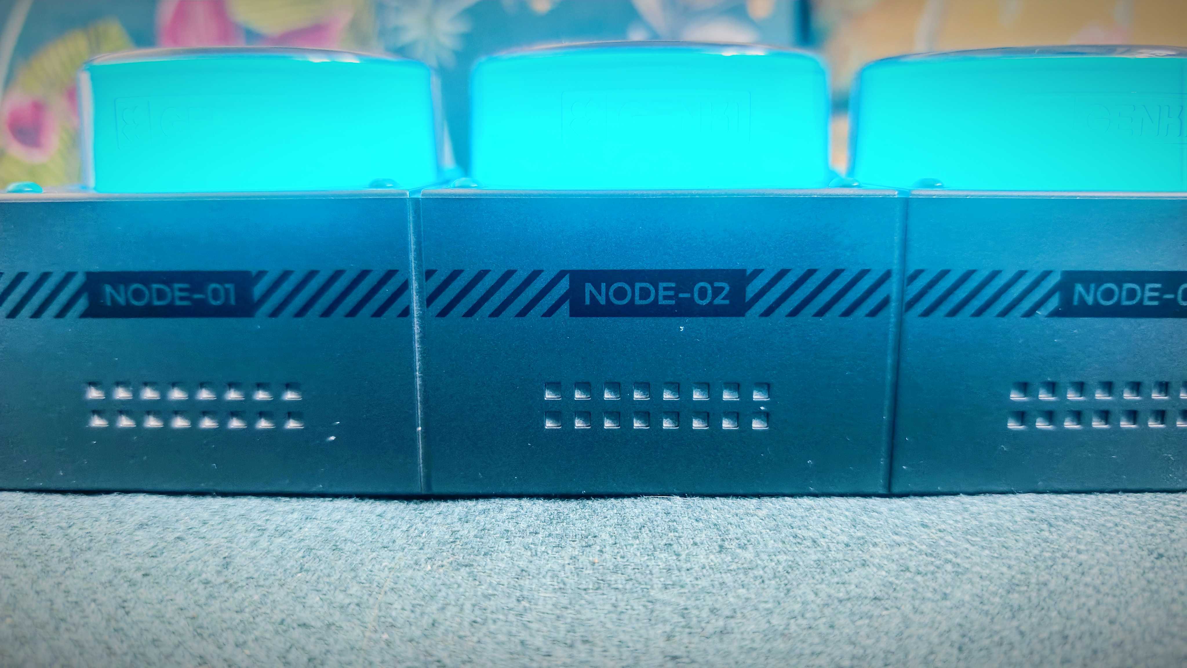 A grey-and-blue Genki Moonbase power strip and charging station sitting on a green sofa