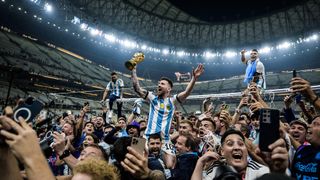 Joel Marklund photograph of the World Cup 2022 showing Lionel Messi holding World Cup aloft among fans