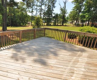 A pine deck with a view of trees