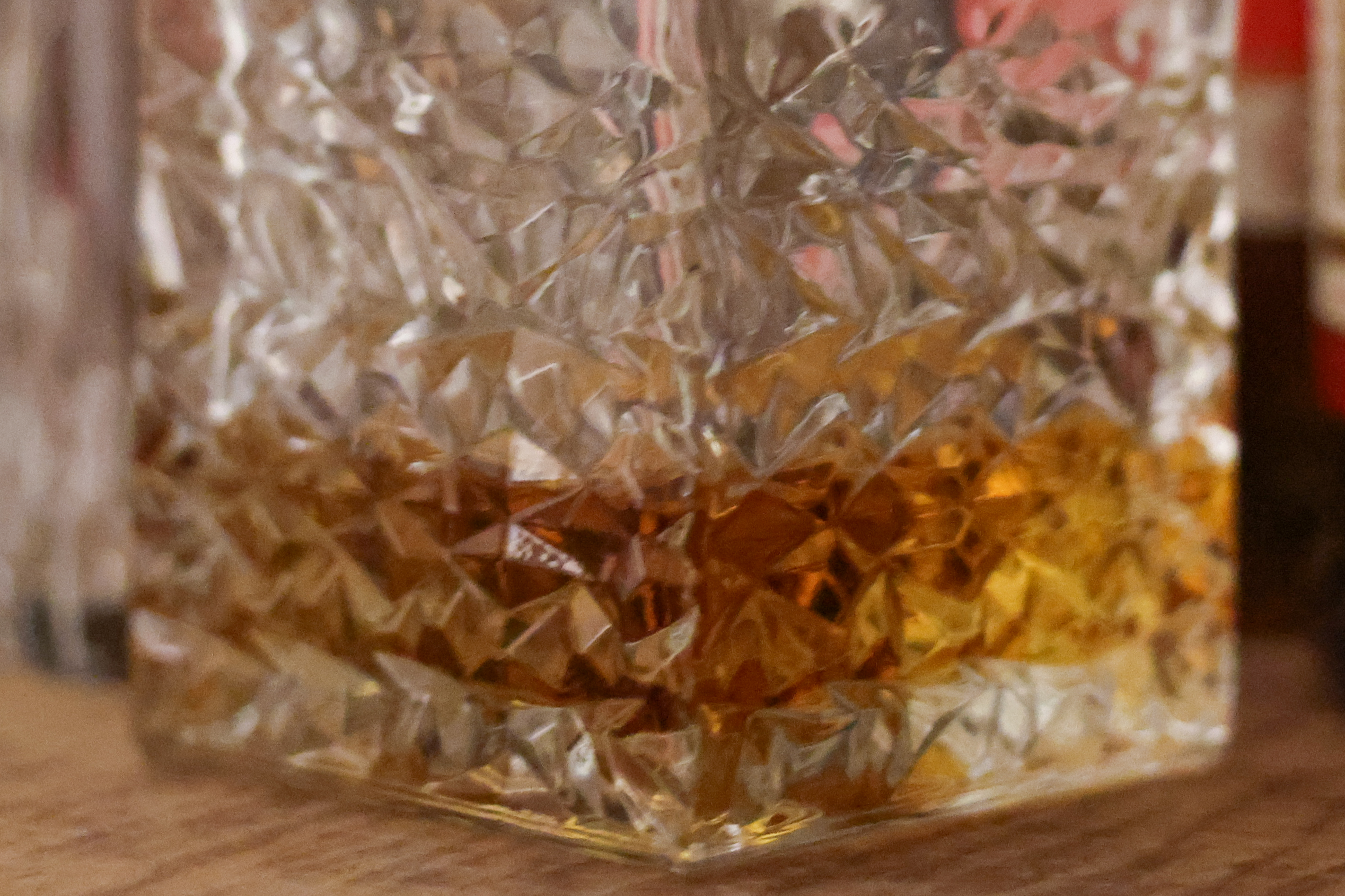 A close crop of the base of a whisky decanter at ISO 12,800