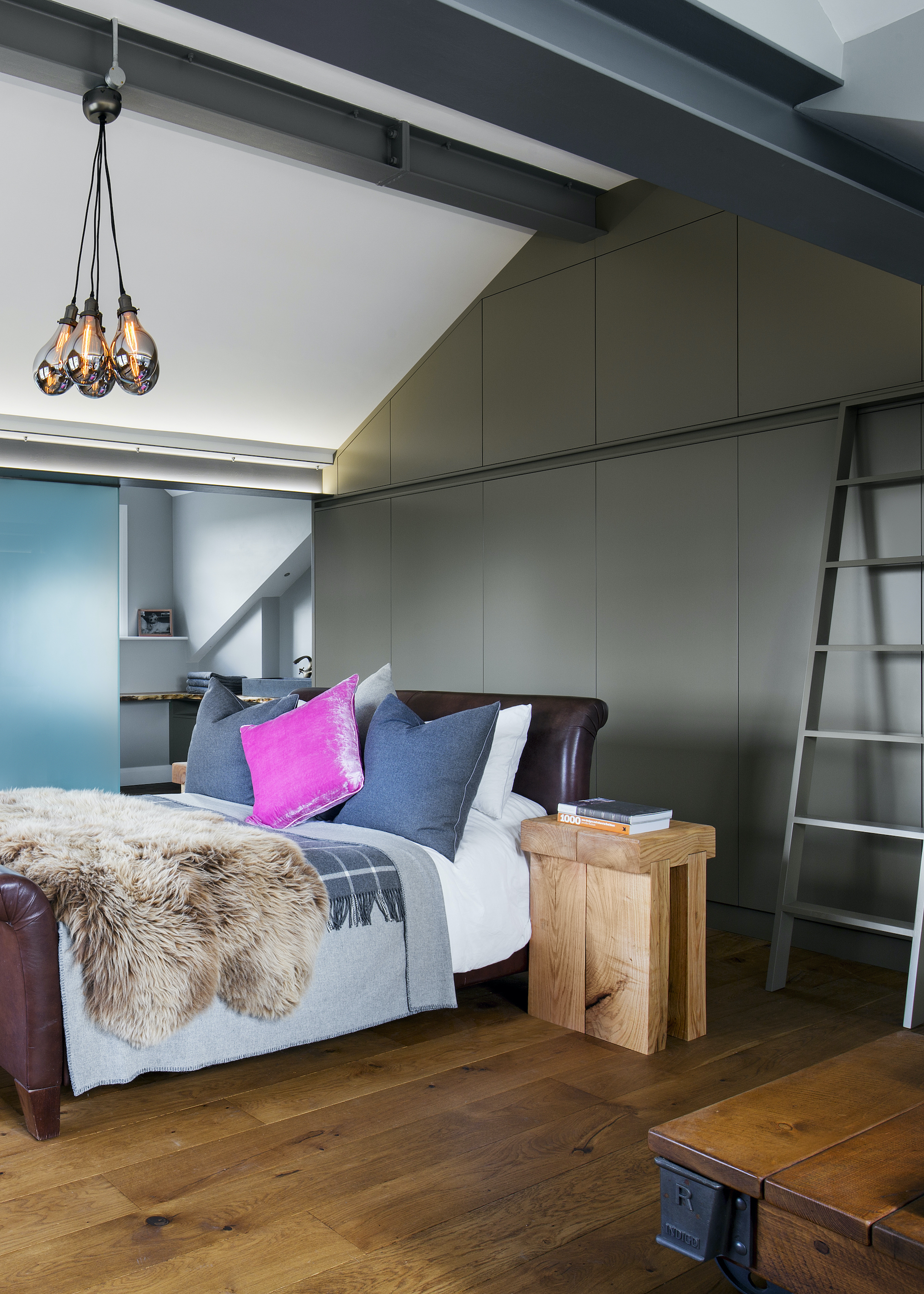 loft bedroom with wood floors and ladder storage