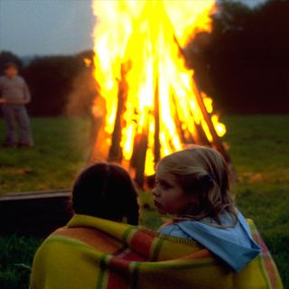 children sitting near bonfire