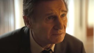 Liam Neeson looks up with tears in his eyes in The Naked Gun 2025.