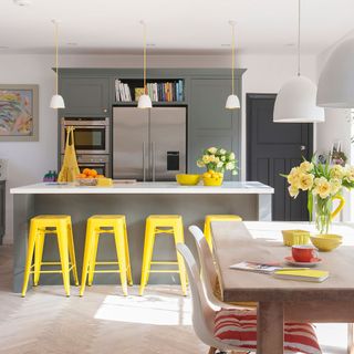 kitchen area with worktop and yellow chairs