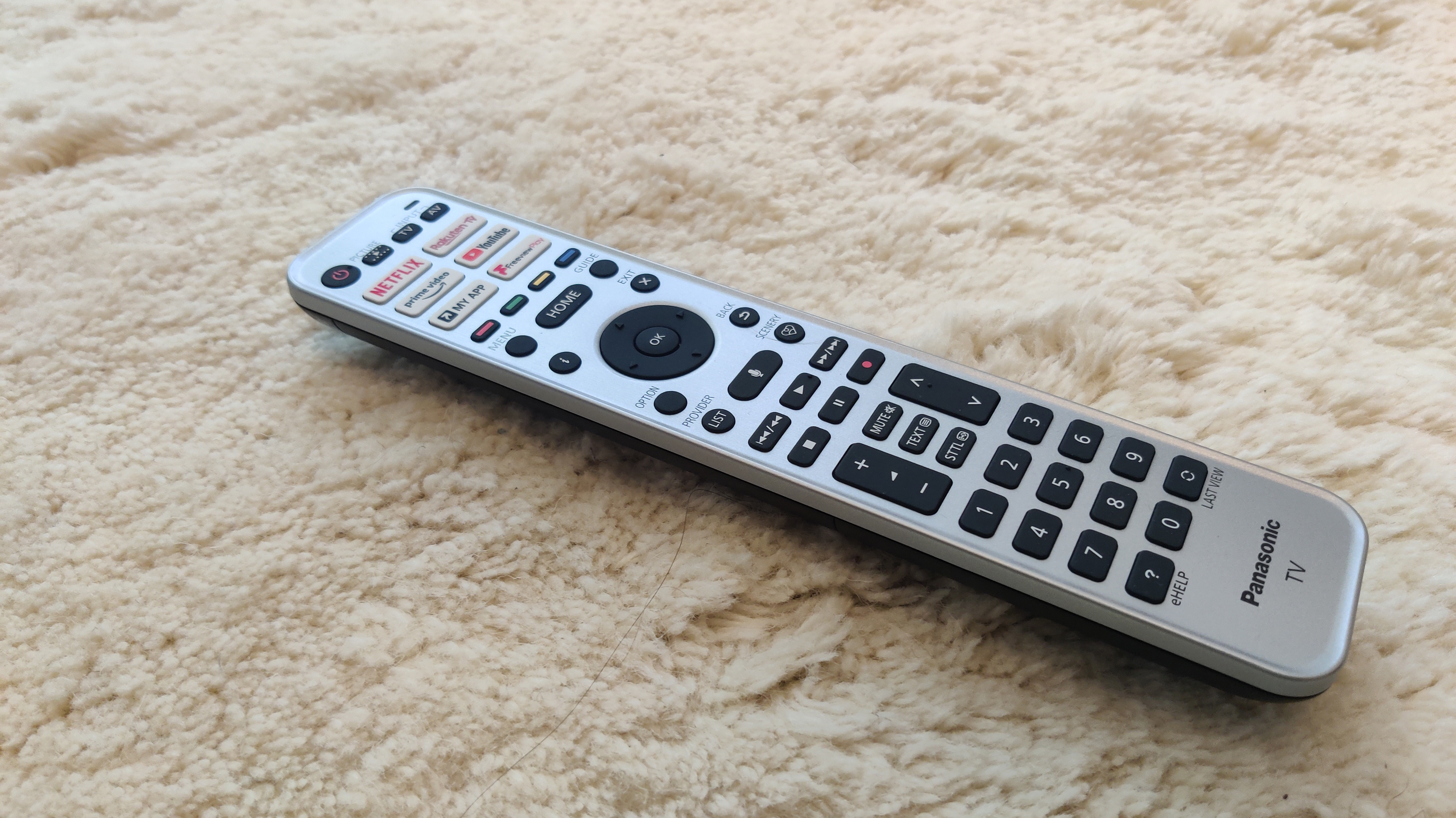 Panasonic JZ2000's remote, resting on white carpet