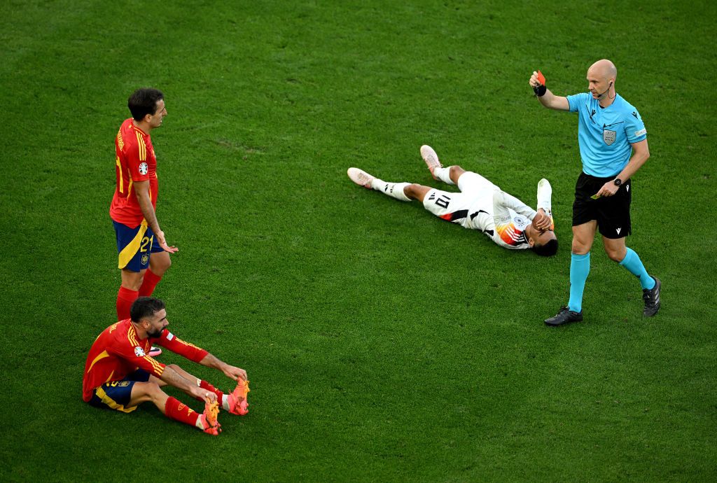 Referee Anthony Taylor shows a red card to Daniel Carvajal of Spain during the UEFA EURO 2024 quarter-final match between Spain and Germany at Stuttgart Arena on July 05, 2024 in Stuttgart, Germany