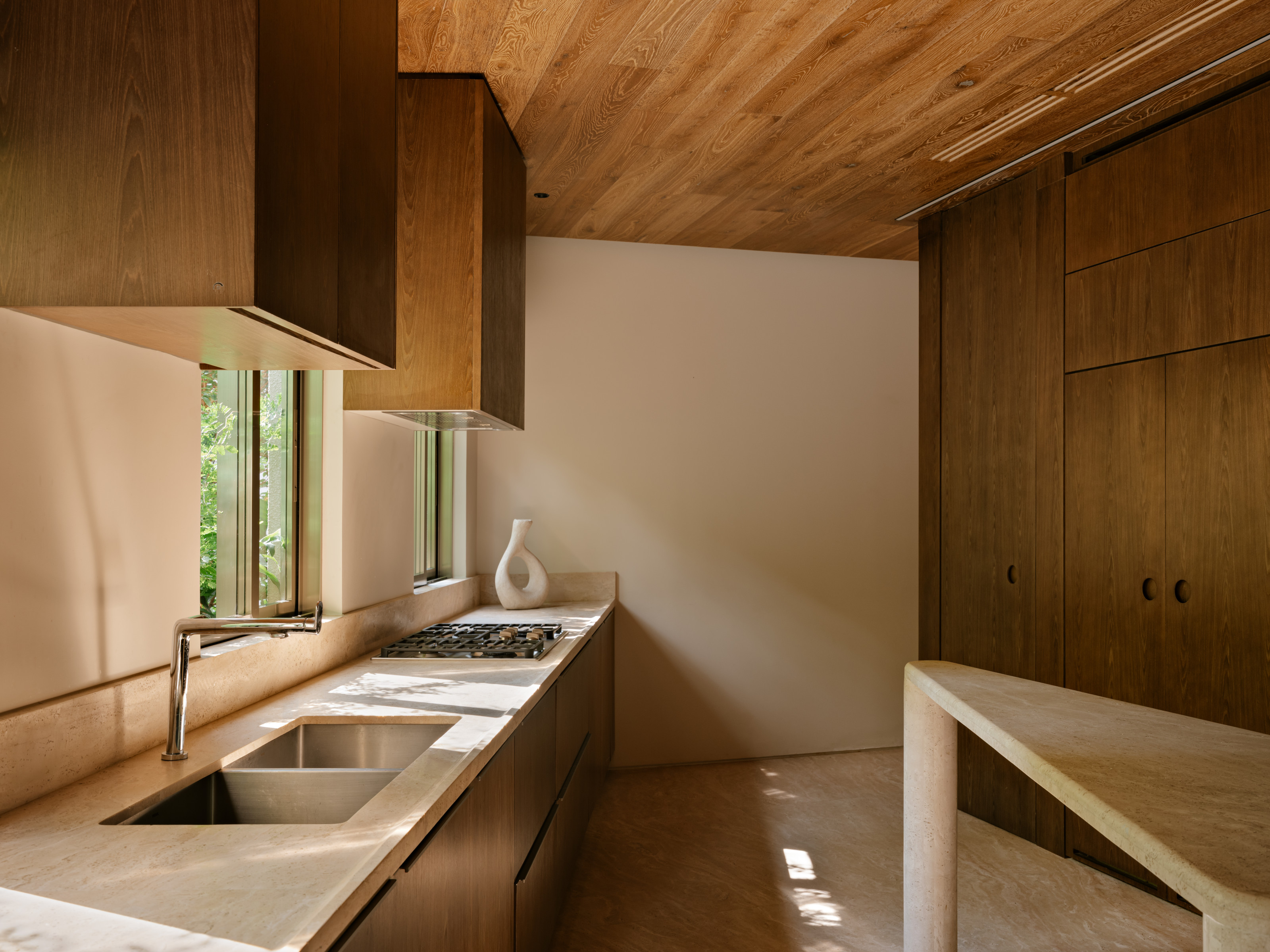 The kitchen has stone worktops and floors