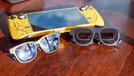 Viture Beast and Xreal 1S on a table with a yellow Steam Deck