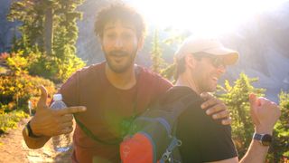 Two guys in a mountainous landscape smiling at the camera