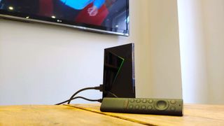 The Nvidia Shield TV Pro all wired up, with the remote in the foreground