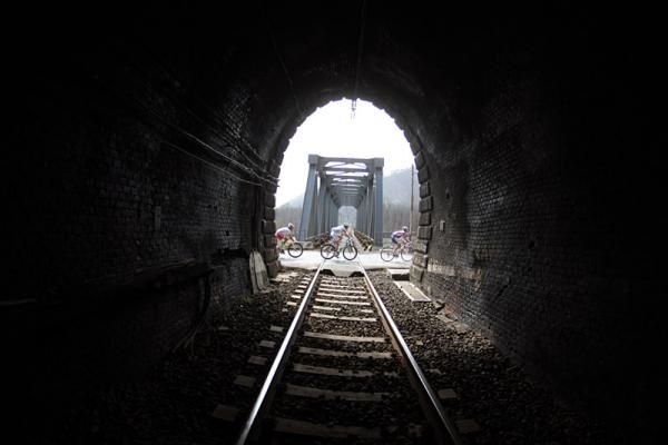 Riders pass by a train tunnel en route to San Remo.