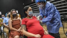 A pregnant woman is inoculated with Pfizer&rsquo;s COVID-19 vaccine in Medellin, Colombia, on July 24, 2021.