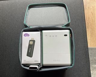 BenQ GS50 Wireless Projector and streaming stick viewed within the open fabric carry case