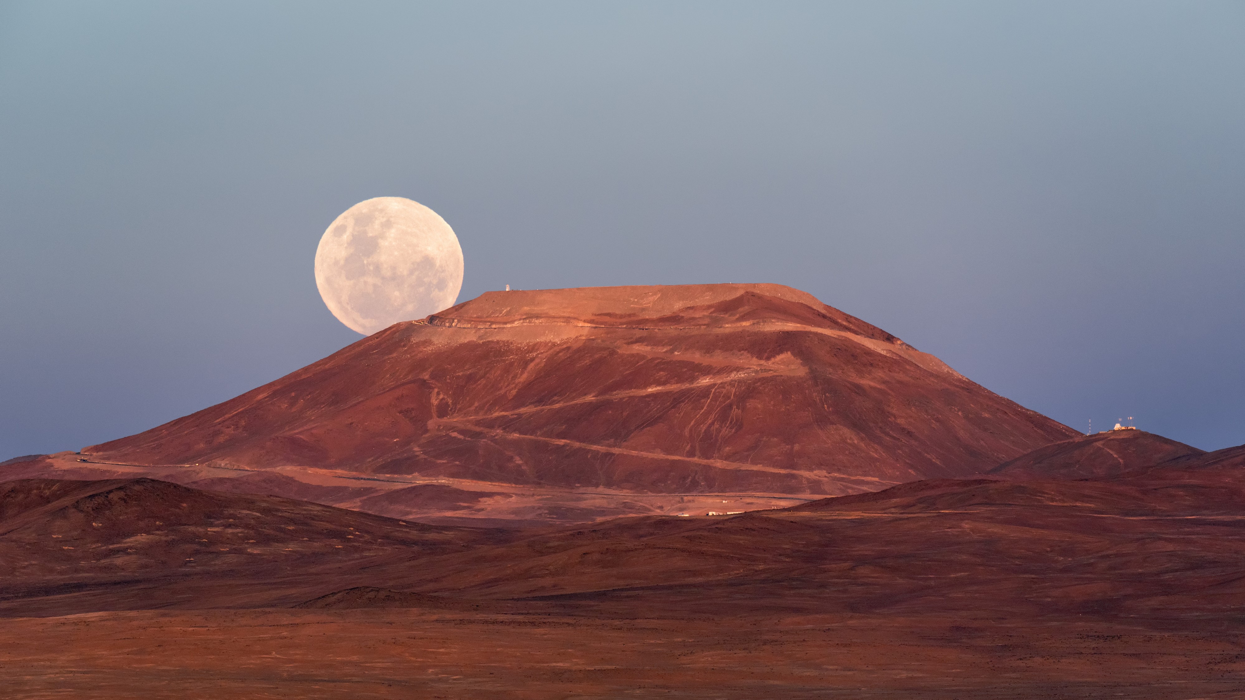 Sometimes the moon can look particularly big when rising or setting near the horizon. This image shows a stunning supermoon rising up from behind the Cerro Armazones mountain in Chile.