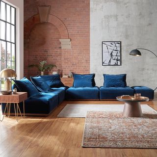 living room with wooden flooring and blue sofaset