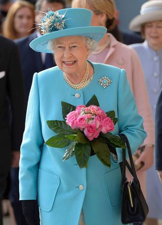 Queen Elizabeth II in matching blue coat dress and hat