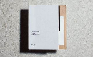 opaque acetate and pearlescent paper invitation, housed inside an unassuming cardboard cover