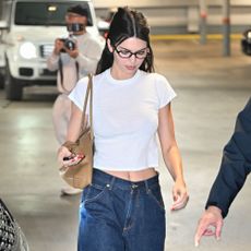 Kendall Jenner wears jeans and a t-shirt with ballet flats.