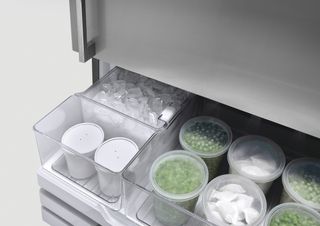 freezer drawers containing frozen food in containers
