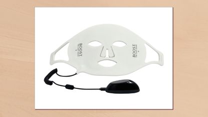 Image of the The Light Salon Boost LED Face Mask in a frame against a beige watercolour-style background