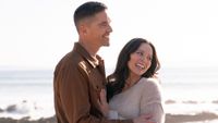 Tim and Lucy embracing each other on the beach after getting engaged in The Rookie's Season 8 finale.