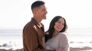 Tim and Lucy embracing each other on the beach after getting engaged in The Rookie's Season 8 finale.