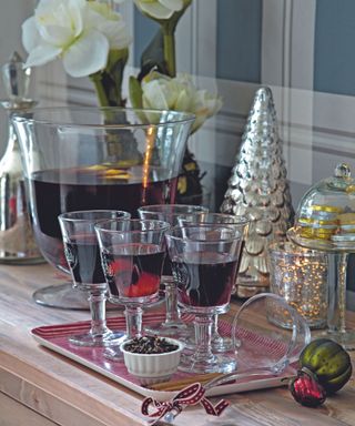 Christmas hallway table with decorations and drinks on