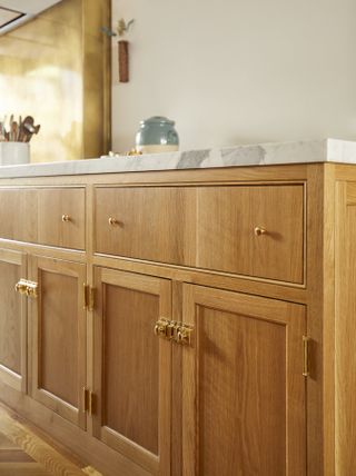 Close up of wooden inset kitchen cabinets with latches