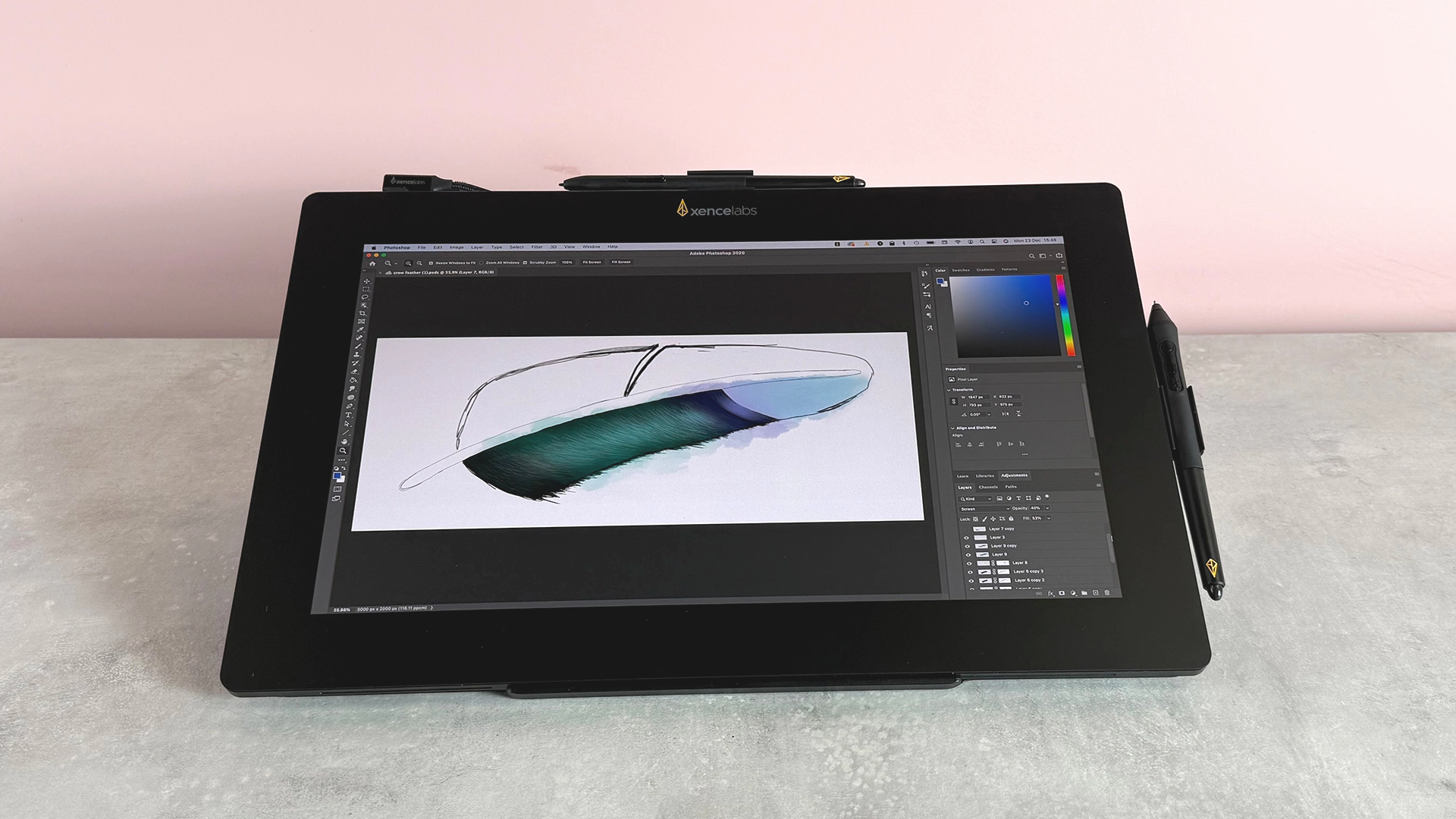The Xencelabs Pen Display 16 featuring a half-finished sketch of a magpie's feather, in front of a pink background.