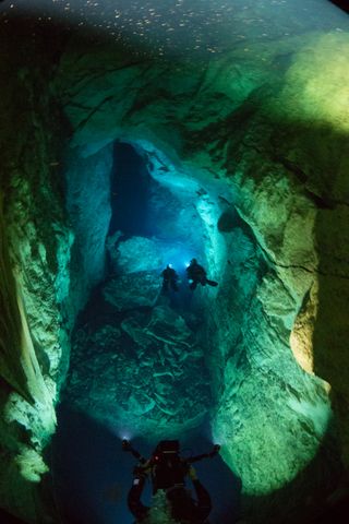 Divers explore Stargate Cave at Andros Island in the Bahamas. The billions of bacteria that live in these caves may provide insight into the possibility of life elsewhere in the universe.