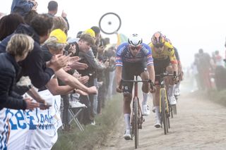 AlpecinDeceuninck teams Dutch rider Mathieu Van Der Poel L and JumboVisma teams Belgian rider Wout Van Aert R cycle in the dust over the cobblestone sector during the 120th edition of the ParisRoubaix oneday classic cycling race between Compiegne and Roubaix northern France on April 9 2023 Photo by AnneChristine POUJOULAT AFP Photo by ANNECHRISTINE POUJOULATAFP via Getty Images