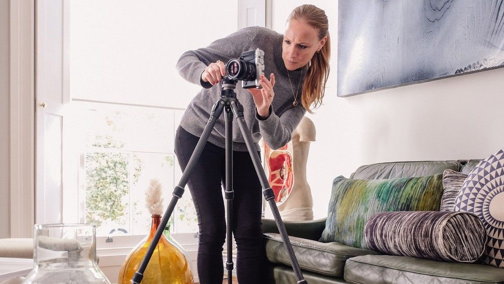 room with camera and tripod stand with sofa