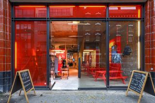 experiential brand design - shop front for Eastpak - red windows and chalkboards outside