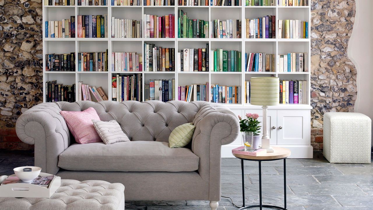 living space with grey sofa and bookshelves