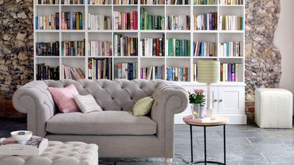 living space with grey sofa and bookshelves